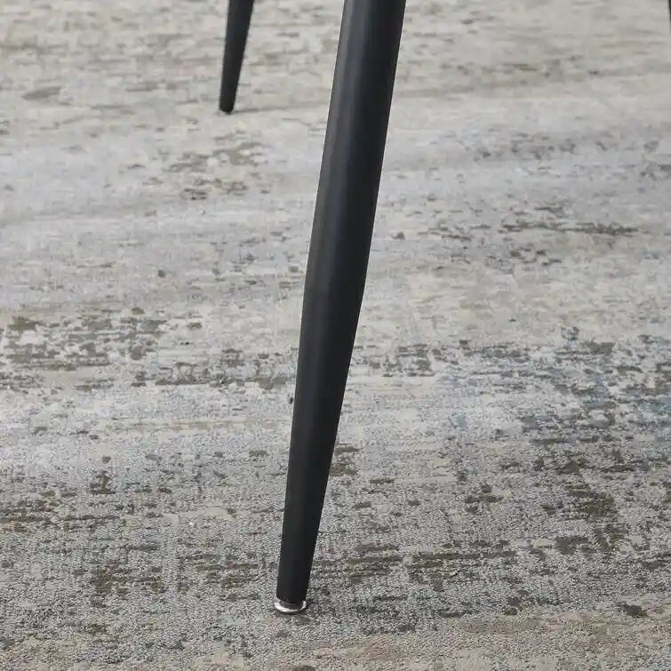 Mesa de comedor rectangular moderna con superficie de piedra y patas de acero negro